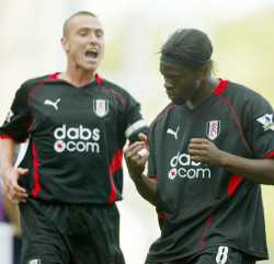 Lee Clark and Louis Saha celebrate a goal a piece